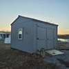 Storage building in front of home with well pump inside. Foam insulation inside shed. 