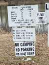 Sign next to public boat dock showing the kind of fish that is stocked in Emerald Lake.  