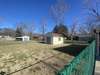 Shed inside fenced in back yard.