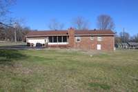 Back of home is fenced with chain link. Garage was converted to a man-cave but could be turned back into a garage. Screened in back porch for enjoying this beautiful back yard.