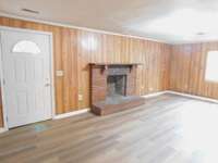 Paneled separate Den w/ replacement Metal Door, Brick Fireplace but  no record of the timeframe for it's use- Local Chimney Sweep can report, perhaps an Insert for wood