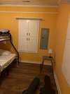 Second bedroom with cabinet door window shutters.