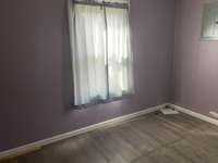 Bedroom previously used as office with vinyl plank flooring