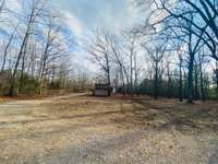 View from the front back. A lot of the land is cleared. Fenced in sections for farm animals if desired. 