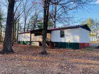 Back of the mobile home with deck/porch area