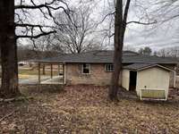 View from the back. Storage building remains, it is not attached to the home.