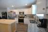 Kitchen with stainless steel appliances and granite countertops and island