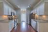 Nice bright kitchen with ample cabinet and counter space.  All appliances convey with the home.