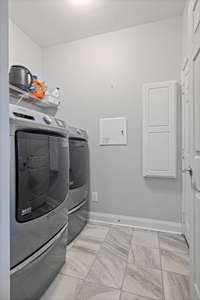 Laundry room with easy access to garage.  Washer/dryer remain with the unit!!