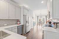 Newly renovated Kitchen:  Soft Close cabinets, quartz countertops, custom backsplash and all new appliances