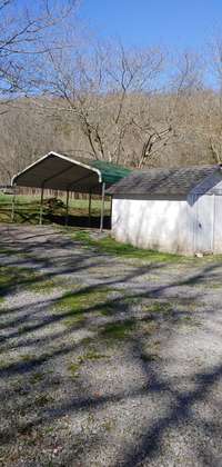 Storage building behind home and carport.