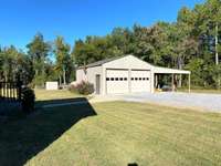 View of the detached garage and carport. Room for your cars and farm equipment