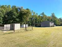 View of the back of the garage, sheds and kennel area. Previous seller trained dogs