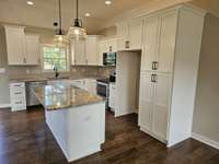 Kitchen with granite countertops and custom cabinetry