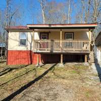 Sunny bright cabin, newer covered front porch for relaxing, Cabin is located across the street from the lake down the hill!  Its ready to short term rental or just a nice smaller family getaway!