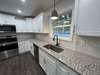 Granite countertops, Stainless Steel Appliances with custom cabinets.