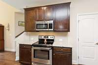 Stainless steel appliances!  The door to the right is the half bath located on this level.