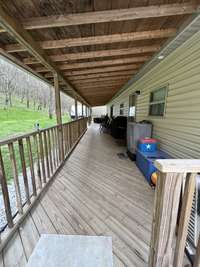 long covered porch the length of home .