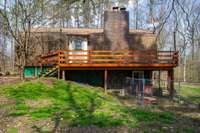 Patio area under the deck leads to the basement area which is currently being used as the master bedroom