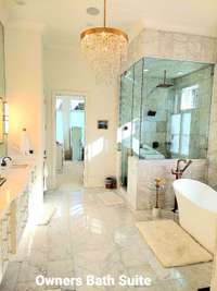 Primary Suite  Spa like bath - Marble floors, showers, & walls. ---  12' Ceilings Steam Sauna Shower included.