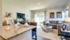 Living Room overlooks covered patio and green space.