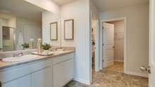 Countertops will be quartz with double sinks in primary bathroom.