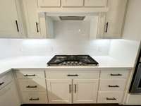 Gas Kitchenaide cooktop! Subway white tile backsplash. 