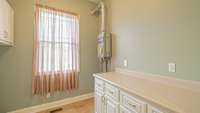 Huge Laundry Room with cabinets and closets for STORAGE.