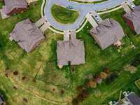 The aerial view of the roundabout front entrance of the house.