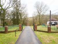 Private gate leading into this wonderful secluded 8 acres so close to everything in Hendersonville