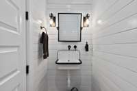 Check out this cute little half bath just inside the door from the back porch. Completely wrapped in shiplap and Old Fashioned style bucket sink.  