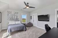 This guest bedroom has an attached bath that shares with the common area upstairs and a walk-in closet. 