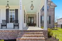 Enjoy mornings or afternoons on this large front porch with tongue and groove bead-board ceilings. 