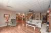 Main living area in basement with fireplace.