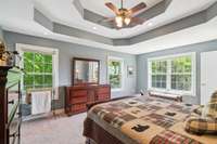 Primary bedroom with loads of natural light and double tray ceiling.