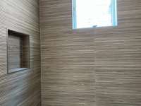 Installed tile in one of the auxiliary bath showers.