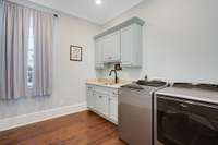 Large laundry room just off the kitchen near the garage entrance.