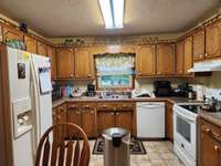 LARGE KITCHEN HAS EXTRA CABINETS & COUNTER SPACE.
