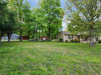 LARGE BARN & DETACHED GARAGE ARE CONVENIENTLY LOCATED.