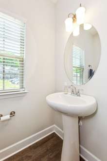 Half bath off the main entry foyer is elegantly simple and full of light.