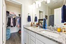 Full bath off the owner's suite has double vanities and granite counters.