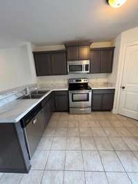 Kitchen with bar seating area and pantry.