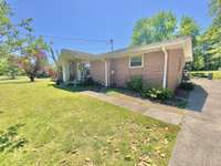 Covered front porch and large concrete driveway