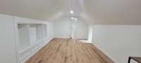 Upstairs loft area with built in bookshelves