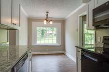 A look from the kitchen into the eat-in area. There is no shortage of natural light in this home!