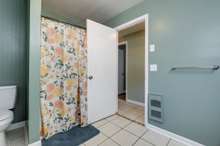 The basement bathroom has a shower/tub enclosure.