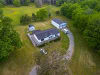 Drone shot with small creek to the right. It is not in a flood plain.