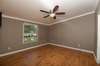 Primary bedroom with ceiling fan.