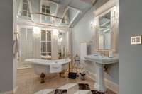 The ensuite bath in Bedroom 3 has a clawfoot tub, gorgeous gold finishes and vaulted ceilings.