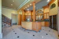 A broader view of the kitchen shows its impressive lighting and space. The kitchen flows directly into the butler's pantry, dining room and great room.